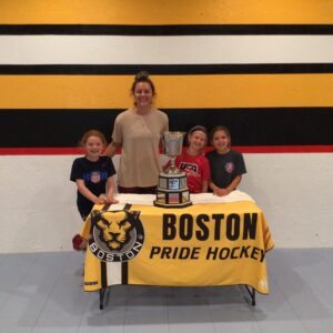 Assabet Valley players Kinley, Hanley and Hillary with Coach Taylor and the Isobel Cup